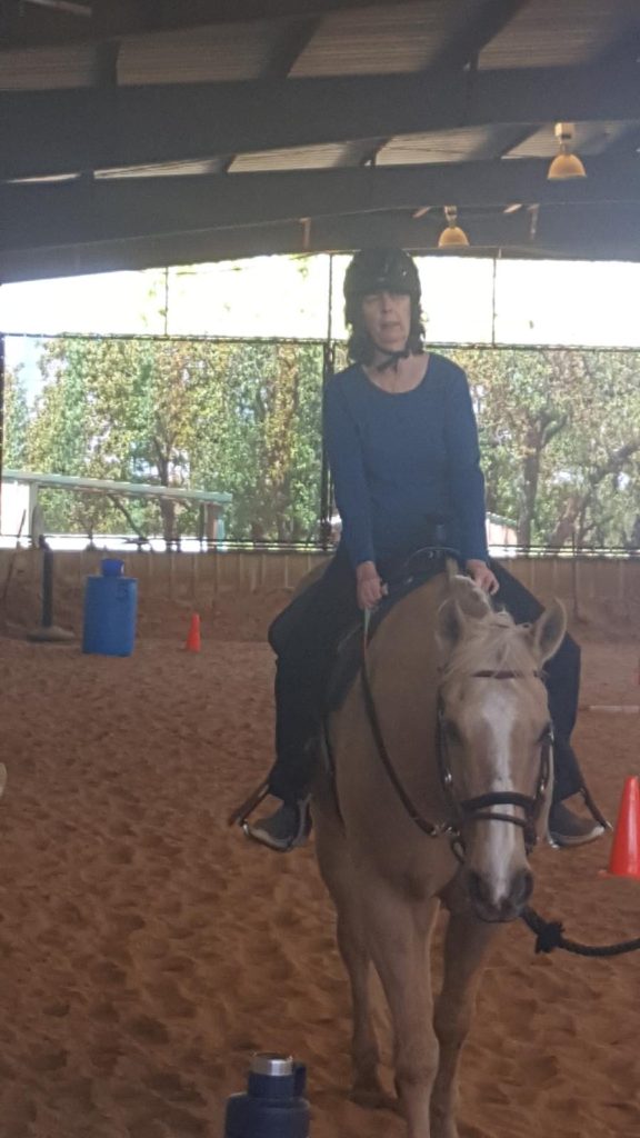 Sharon riding a Gold and White Palomino